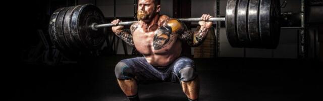 The physics of how Olympic weightlifters exploit barbell's "whip"
