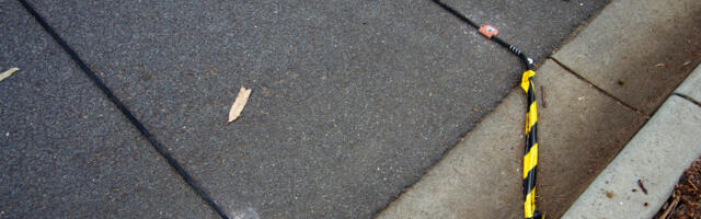Here's What Those Black Cables On The Road Are Actually For