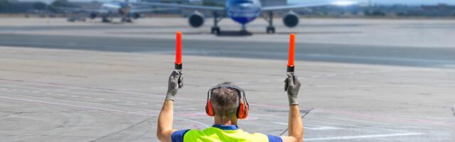 What Does It Mean When An Airline's Ground Crew Member Waves Those Lights Around?