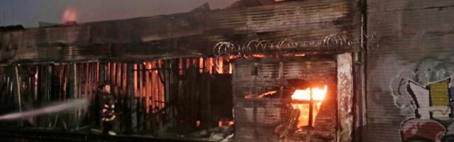Huge Oakland lumber yard blaze smolders as firefighters stay on guard