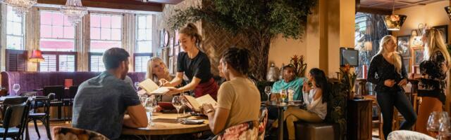 I stack my plates, fold my napkin, and push my chair in every time I leave a restaurant table — and I have never been able to stop doing it, not because anyone is watching, but because my mother was a waitress for eleven years and I have never once in my adult life been able to look at a messy table and not see it through her feet