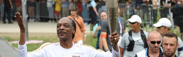 Snoop Dogg carries the Olympic torch before opening ceremony in Paris