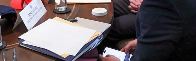 Photo appears to show now-former national security advisor Mike Waltz checking Signal during a Cabinet meeting