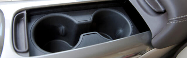 This May Be What The Gap In Between Your Car's Cup Holders Is Actually For