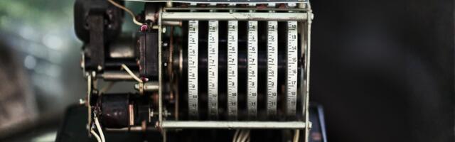 In 1944, an IBM machine called the Harvard Mark I clattered through a calculation for the Manhattan Project at three additions per second, fed by paper tape and operated by a young Navy lieutenant named Grace Hopper who took the graveyard shift more often than anyone and slept beside it on a cot, waking the moment the relays went quiet because a silent machine meant something had gone wrong